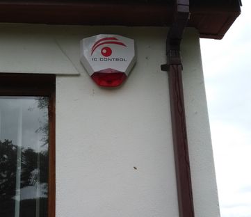 IC Contol Alarm placed on side of house 